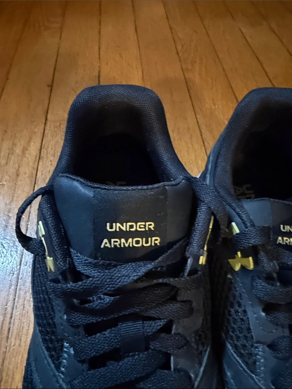 Under Armour Black Athletic Shoes with Gold Logo Accents